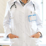 silhueta de médica que usa jaleco branco e estetoscópio; pesquisa apontaa importância de políticas voltadas ao bem-estar dos trabalhadores de saúde