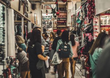Aglomeração de pessoas em corredor de centro comercial