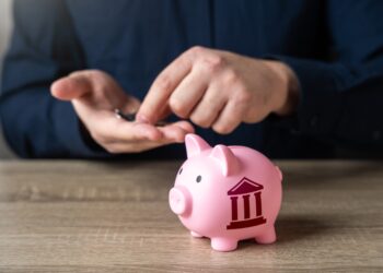 Gráfico de orçamento público em frente a uma prefeitura ilustrando a saúde fiscal dos municípios brasileiros e seus principais indicadores financeiros.